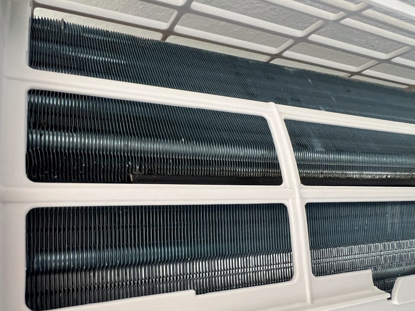 Close-up of clean AC evaporator coils after professional deep clean, fins clear and undamaged.